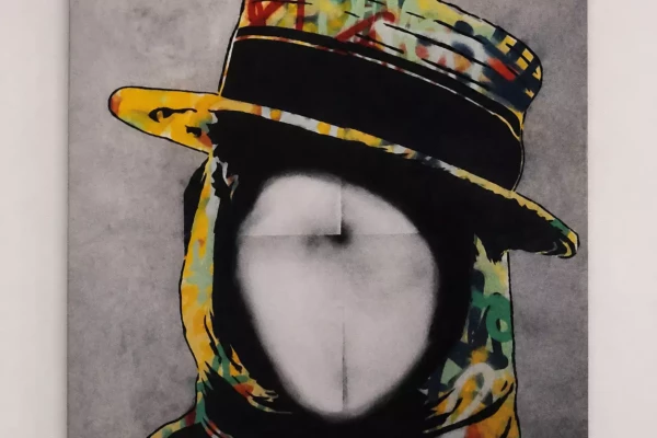 Tableau de l'artiste Paul Wal à Genève représentant un visage  réalisé avec des pochoirs et des bombonnes de spray de peinture.
